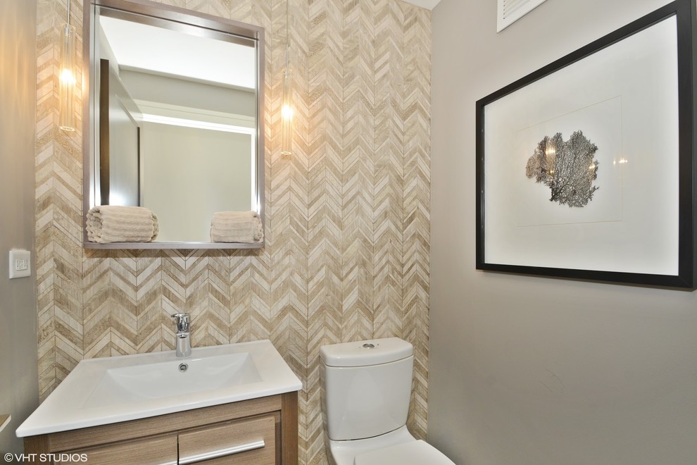 This is an example of a small contemporary powder room in Chicago with flat-panel cabinets, light wood cabinets, a one-piece toilet, beige tile, stone tile, beige walls, dark hardwood floors, an undermount sink, engineered quartz benchtops and brown floor.