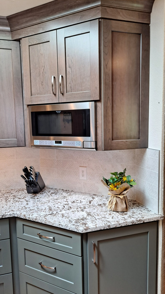 Kitchen - mid-sized transitional galley light wood floor kitchen idea in Denver with shaker cabinets, porcelain backsplash and stainless steel appliances