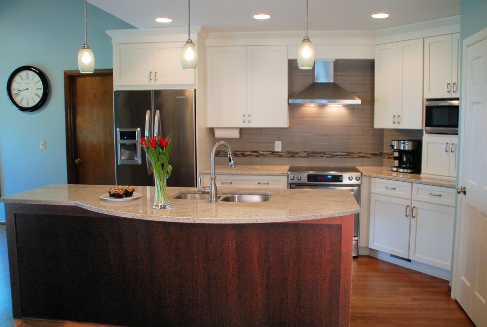 Small transitional single-wall medium tone wood floor eat-in kitchen photo in Columbus with an undermount sink, shaker cabinets, white cabinets, granite countertops, gray backsplash, ceramic backsplash, stainless steel appliances and an island