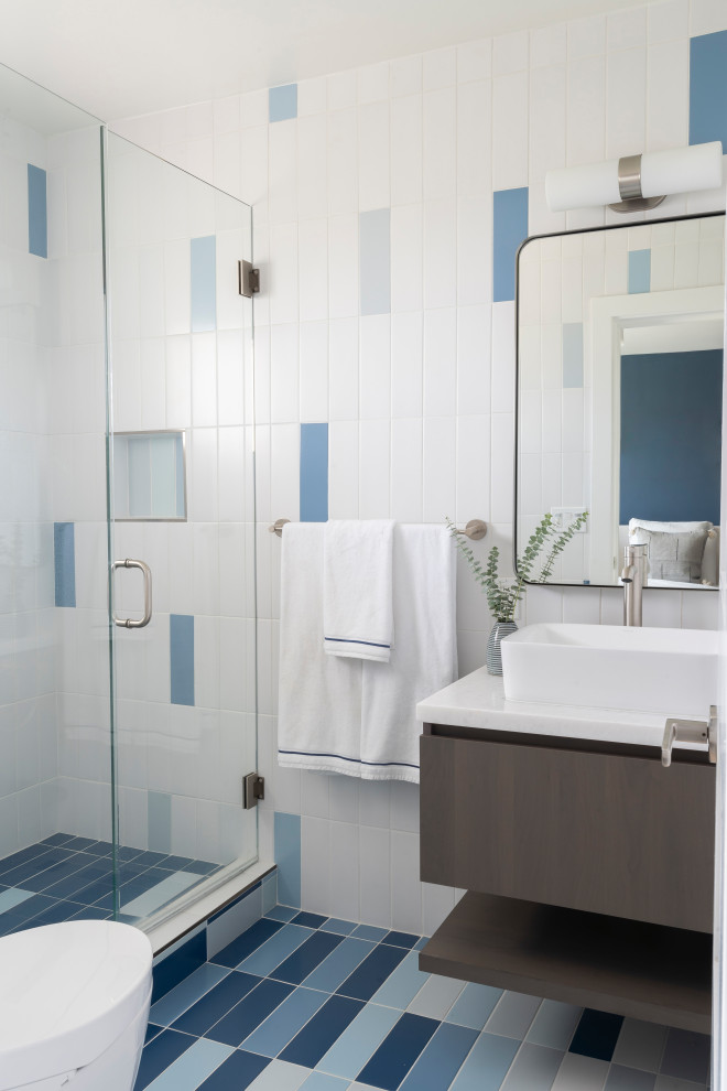 Inspiration for a small beach style 3/4 bathroom in Los Angeles with marble benchtops, flat-panel cabinets, brown cabinets, a floating vanity, an alcove shower, blue tile, multi-coloured tile, white tile, multi-coloured walls, a vessel sink, multi-coloured floor, a hinged shower door, white benchtops, a niche and a single vanity.