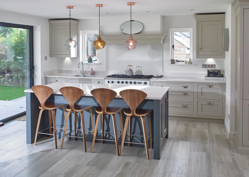 Inspiration for a mid-sized transitional single-wall eat-in kitchen in Other with quartzite benchtops, with island, an undermount sink, shaker cabinets, grey cabinets, stainless steel appliances, grey floor, white benchtop, white splashback and porcelain floors.