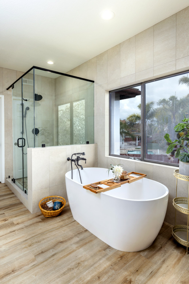Large transitional master beige tile and ceramic tile vinyl floor, brown floor and double-sink bathroom photo in San Diego with shaker cabinets, white cabinets, a two-piece toilet, beige walls, an undermount sink, quartzite countertops, a hinged shower door, gray countertops and a niche
