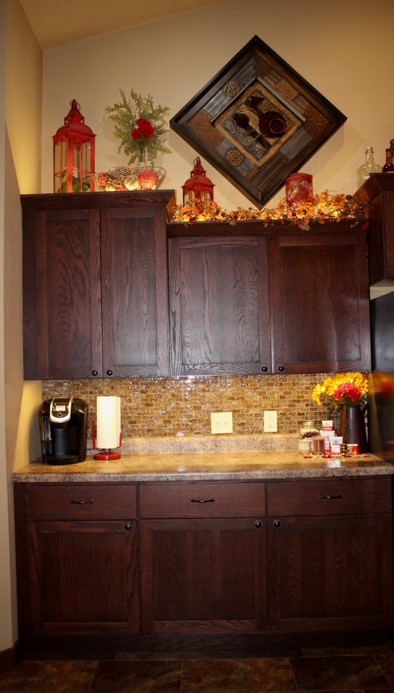 Example of a large transitional single-wall slate floor and beige floor enclosed kitchen design in Cedar Rapids with shaker cabinets, dark wood cabinets, limestone countertops, beige backsplash, mosaic tile backsplash, stainless steel appliances and no island