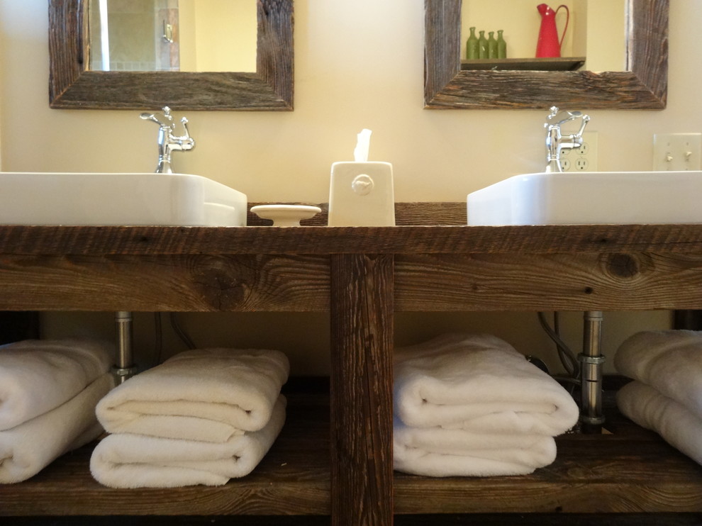 Example of a mid-sized mountain style master beige tile and ceramic tile ceramic tile corner bathtub design in Charlotte with a drop-in sink, furniture-like cabinets, dark wood cabinets, wood countertops, a two-piece toilet and beige walls