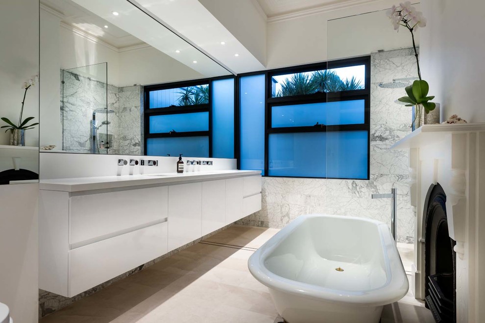 Mid-sized transitional master bathroom in Perth with white cabinets, a claw-foot tub, an open shower, a one-piece toilet, gray tile, marble, white walls, marble floors, an undermount sink, laminate benchtops, beige floor, an open shower and white benchtops.