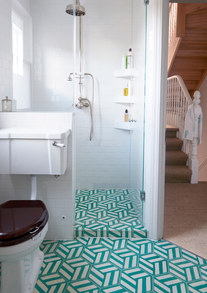 Mid-sized transitional bathroom in London with a drop-in tub, an open shower, a two-piece toilet, blue tile, white tile, white walls, ceramic floors, cement tile and turquoise floor.
