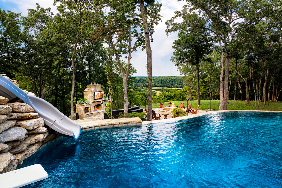 Large country backyard pool in Other with natural stone pavers.