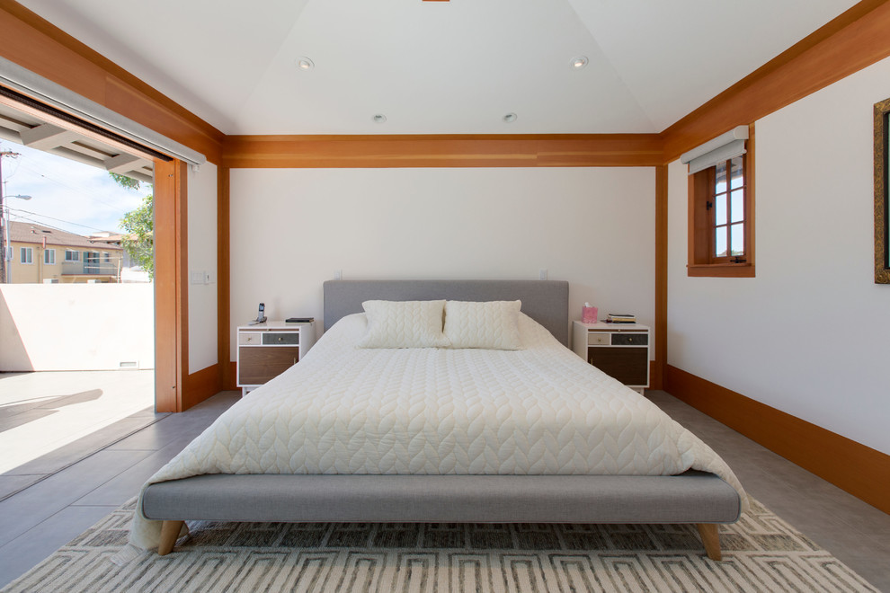 Photo of a mid-sized transitional master bedroom in San Diego with white walls, concrete floors and no fireplace.