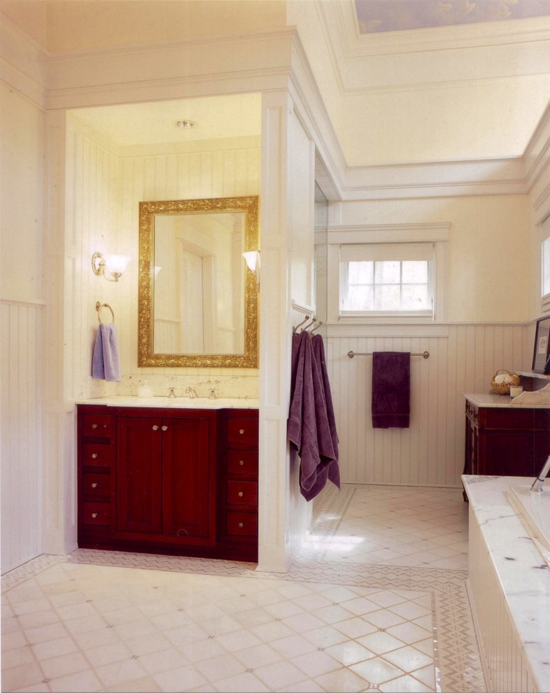 Design ideas for an expansive master bathroom in New York with furniture-like cabinets, medium wood cabinets, a drop-in tub, white tile, an undermount sink, marble benchtops, an alcove shower, porcelain tile, white walls and porcelain floors.