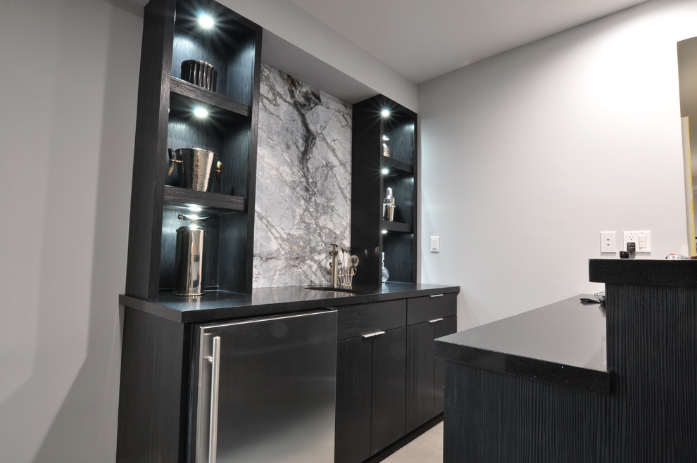 This is an example of a small contemporary galley wet bar in Los Angeles with flat-panel cabinets, dark wood cabinets, granite benchtops, grey splashback and stone slab splashback.