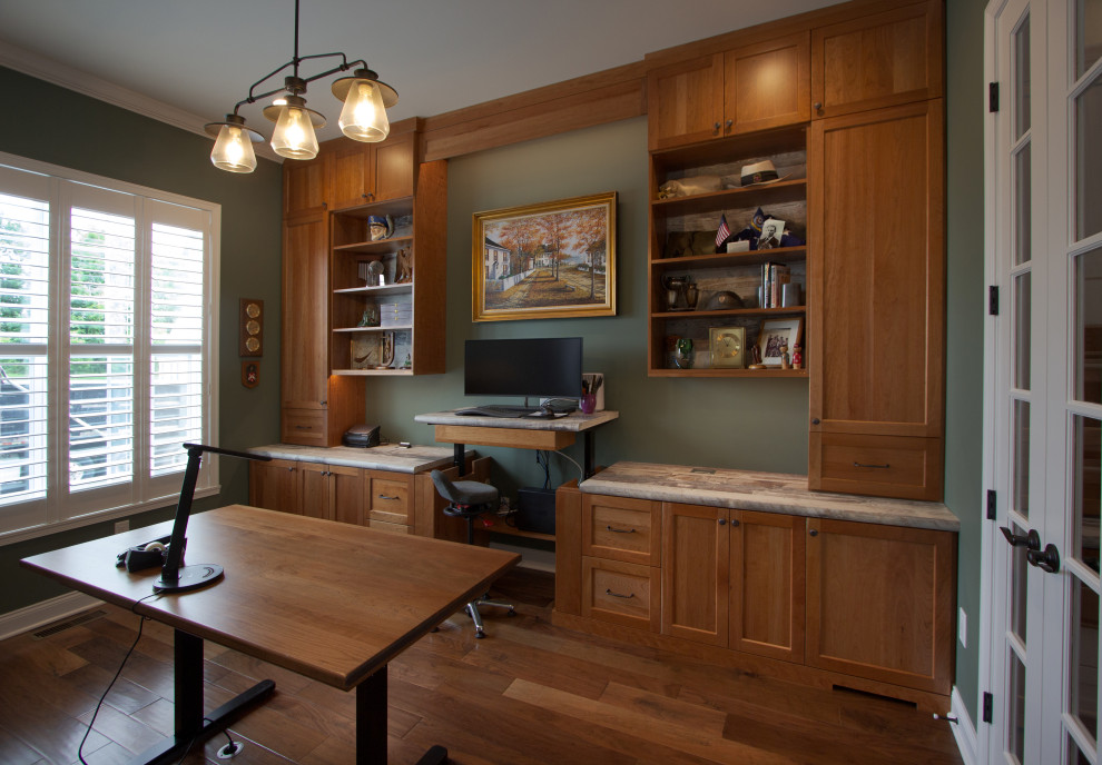 На фото: кабинет среднего размера в классическом стиле с зелеными стенами, паркетным полом среднего тона, встроенным рабочим столом и коричневым полом с