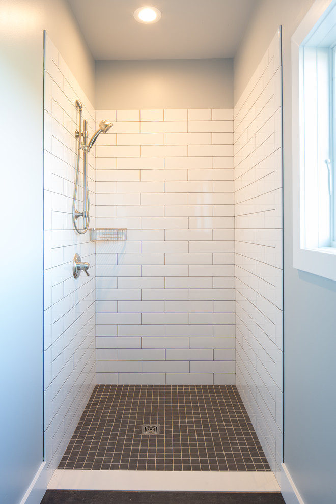 This is an example of a mid-sized country master bathroom in Detroit with open cabinets, brown cabinets, a claw-foot tub, a corner shower, a two-piece toilet, white tile, subway tile, grey walls, dark hardwood floors, a wall-mount sink, wood benchtops, brown floor, a hinged shower door and brown benchtops.