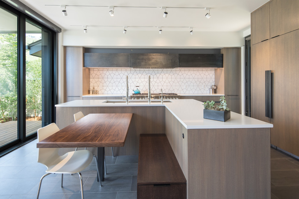 Photo of a contemporary eat-in kitchen in Denver with an undermount sink, flat-panel cabinets, white splashback, panelled appliances and grey floor.