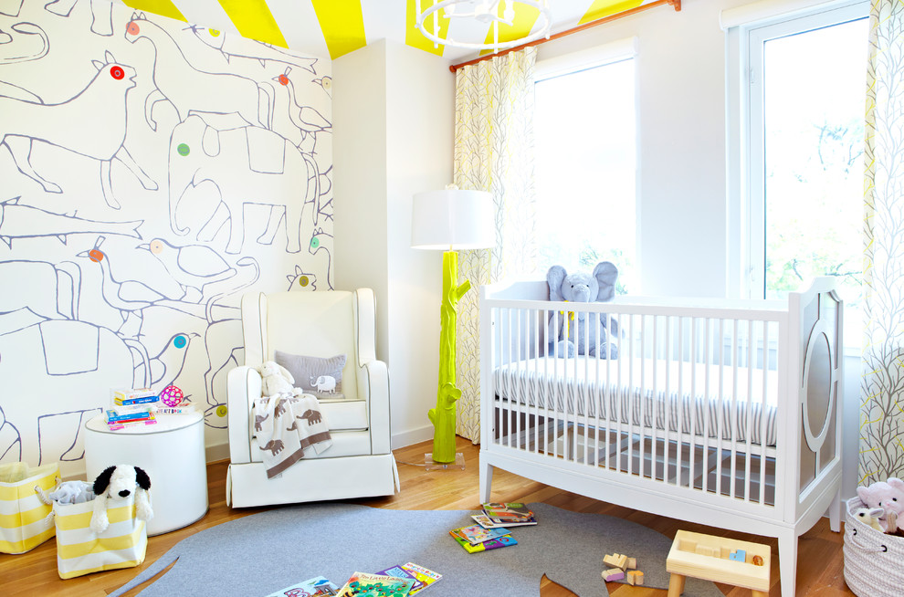 Contemporary gender-neutral nursery in New York with white walls and medium hardwood floors.