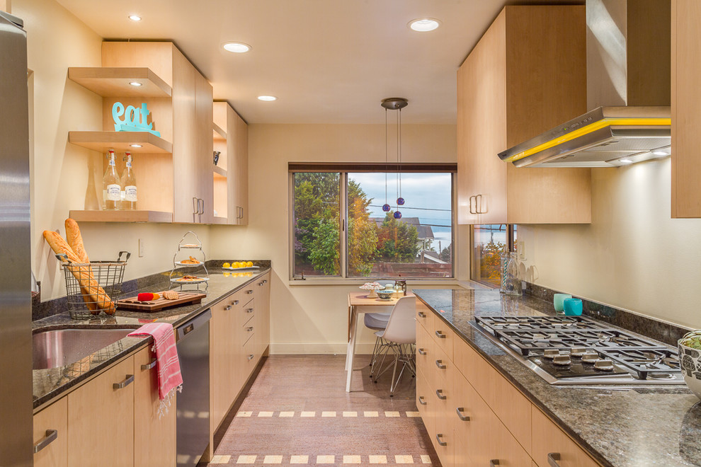 Inspiration for a contemporary galley eat-in kitchen in Seattle with an undermount sink, flat-panel cabinets, light wood cabinets, stainless steel appliances and no island.