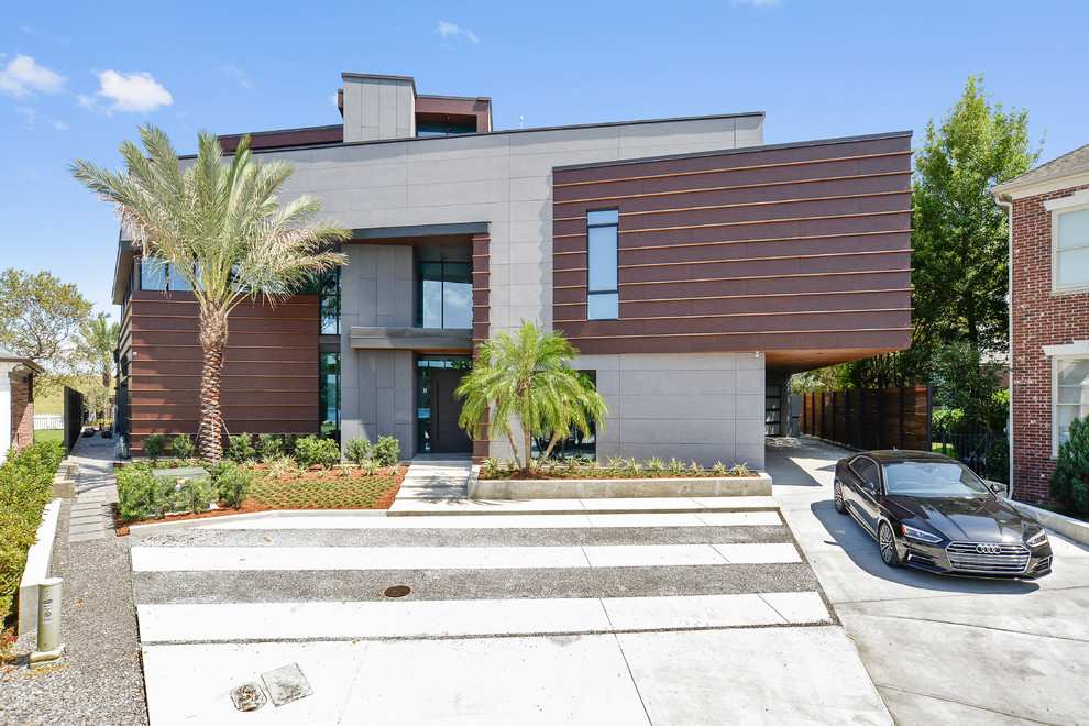 Expansive and brown modern detached house in New Orleans with three floors, a flat roof and a black roof.
