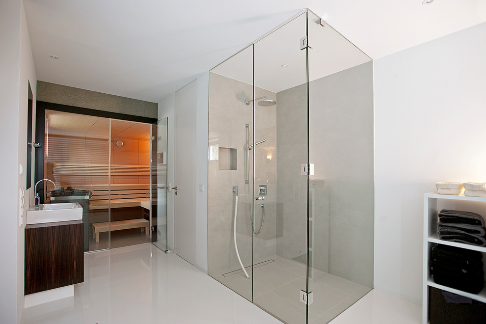 This is an example of a contemporary bathroom in Other with a curbless shower and a hinged shower door.