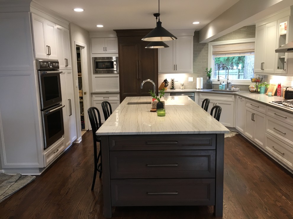 Inspiration for a large transitional u-shaped dark wood floor and brown floor open concept kitchen remodel in Chicago with an undermount sink, flat-panel cabinets, white cabinets, quartz countertops, gray backsplash, ceramic backsplash, stainless steel appliances, an island and gray countertops
