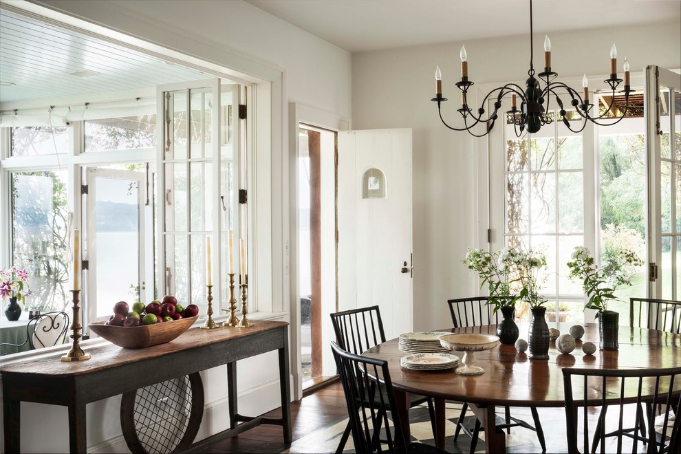 Design ideas for a traditional separate dining room in New York with white walls and dark hardwood floors.