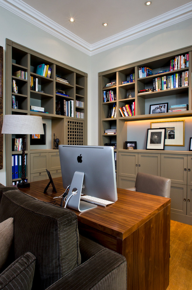Transitional home office in London with a freestanding desk.