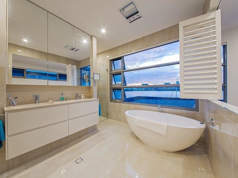Photo of a mid-sized contemporary master bathroom in Brisbane with an undermount sink, white cabinets, engineered quartz benchtops and porcelain floors.