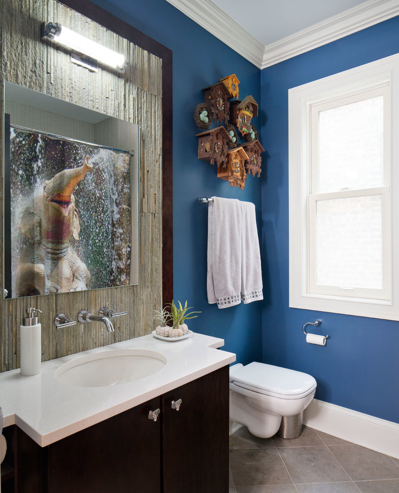 Photo of a mid-sized transitional kids bathroom in Chicago with an undermount sink, flat-panel cabinets, dark wood cabinets, a wall-mount toilet, stone tile, limestone benchtops, gray tile and porcelain floors.
