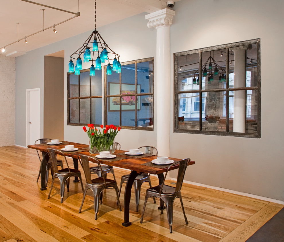 Industrial dining room in New York with grey walls.