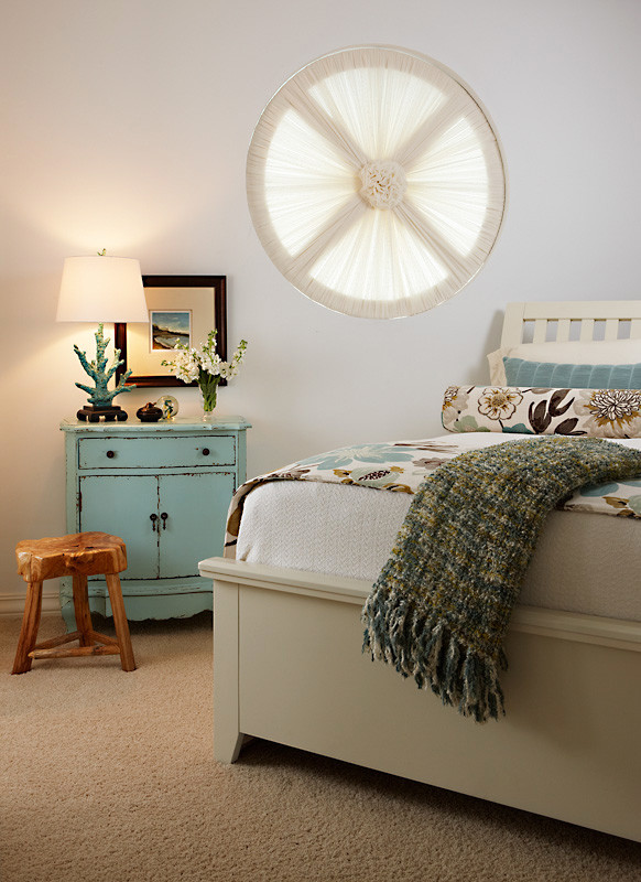 Design ideas for a mid-sized beach style guest bedroom in Other with beige walls and carpet.