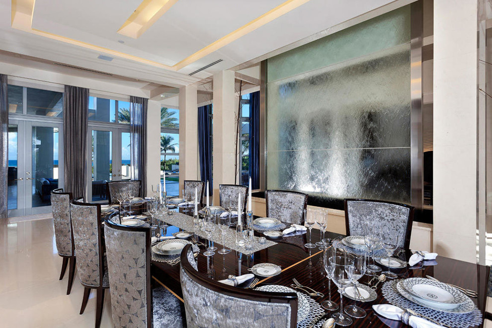Photo of an expansive contemporary separate dining room in Miami with metallic walls and marble floors.
