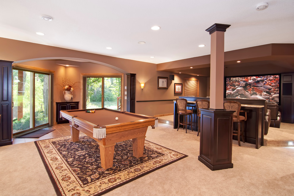 This is an example of a large traditional family room in Minneapolis with brown walls and carpet.