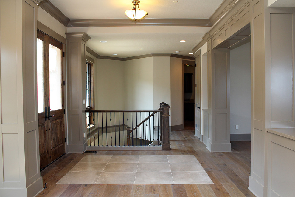 Design ideas for a large arts and crafts front door in Portland with beige walls, medium hardwood floors, a double front door and a dark wood front door.