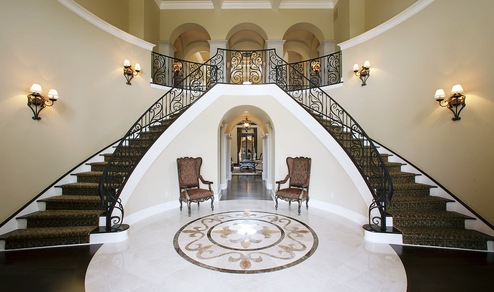 Inspiration for a large mediterranean foyer in Columbus with beige walls and marble floors.