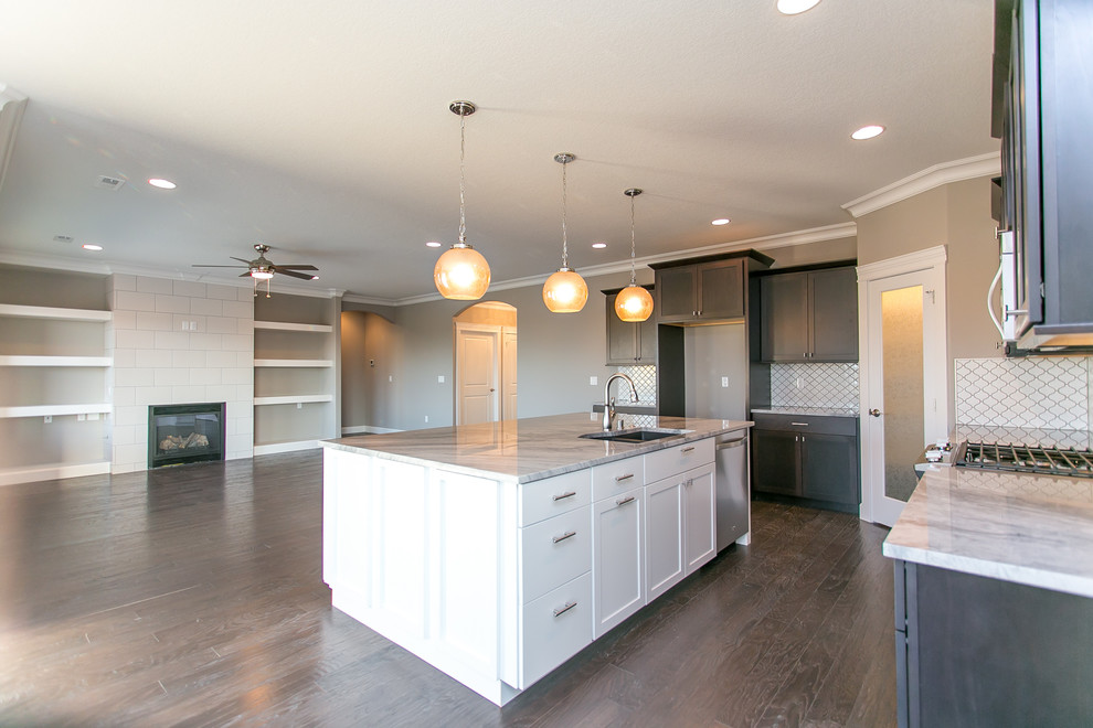 Inspiration for a mid-sized transitional l-shaped dark wood floor open concept kitchen remodel in Seattle with an undermount sink, shaker cabinets, dark wood cabinets, granite countertops, white backsplash, porcelain backsplash, stainless steel appliances and an island