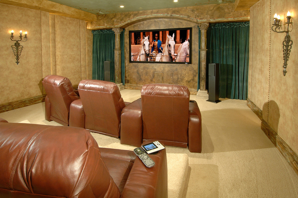 Photo of a mid-sized traditional enclosed home theatre in Austin with beige walls, carpet and a projector screen.
