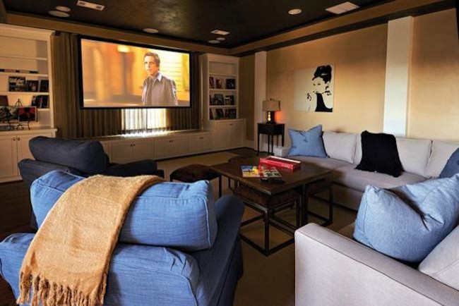 This is an example of a mid-sized traditional enclosed home theatre in Dallas with beige walls, a projector screen, medium hardwood floors and brown floor.