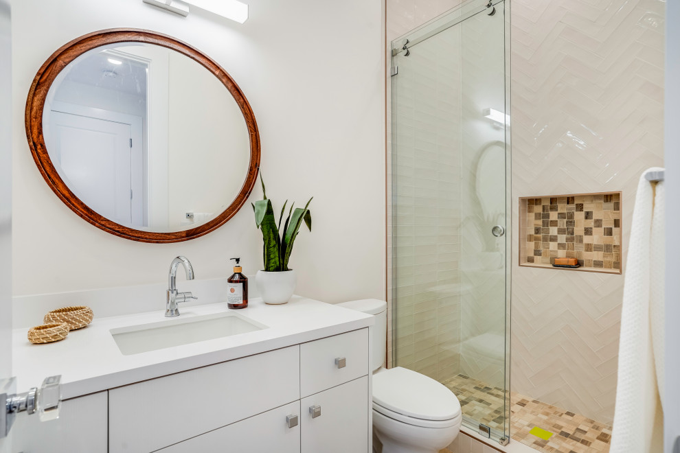 Inspiration for a contemporary bathroom in San Francisco with flat-panel cabinets, white cabinets, an alcove shower, a two-piece toilet, white tile, white walls, an undermount sink, a sliding shower screen, white benchtops, a single vanity and a freestanding vanity.