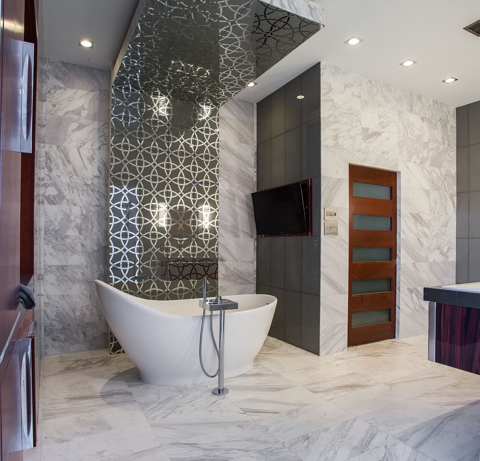 Design ideas for an expansive modern master bathroom in Houston with furniture-like cabinets, dark wood cabinets, a freestanding tub, an open shower, a two-piece toilet, gray tile, grey walls, marble floors, an undermount sink, quartzite benchtops, marble, grey floor and grey benchtops.