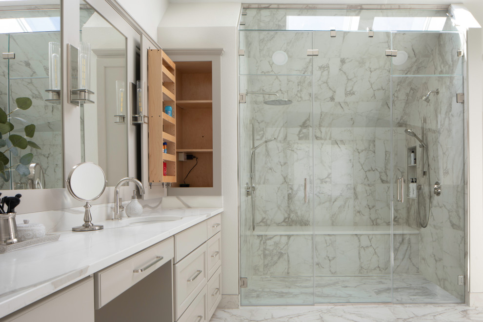 Inspiration for a large transitional master bathroom in Milwaukee with grey cabinets, a freestanding tub, a curbless shower, porcelain tile, porcelain floors, an undermount sink, engineered quartz benchtops, a hinged shower door, a shower seat, a double vanity, a built-in vanity and vaulted.