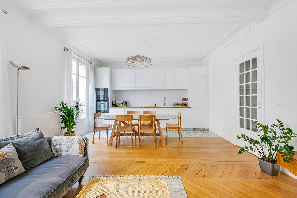 Inspiration for a large scandinavian single-wall eat-in kitchen in Paris with a drop-in sink, white cabinets, wood benchtops, white splashback, metal splashback, cement tiles and no island.