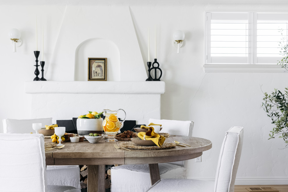 Idee per una sala da pranzo mediterranea con parquet chiaro e camino classico