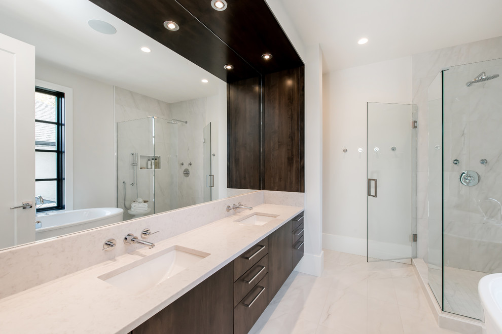 Large transitional master white tile and ceramic tile marble floor freestanding bathtub photo in Calgary with an undermount sink, flat-panel cabinets, dark wood cabinets, quartz countertops and white walls