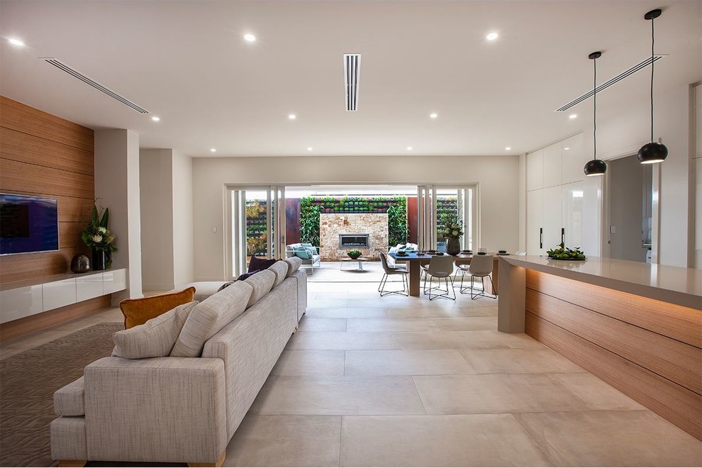 Photo of a large modern backyard patio in Adelaide with a fire feature and tile.