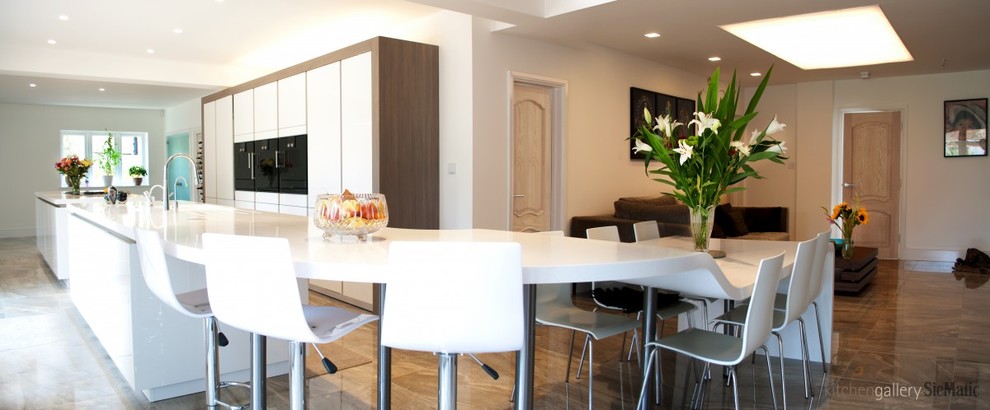 Inspiration for an expansive contemporary open plan kitchen in West Midlands with multiple islands.