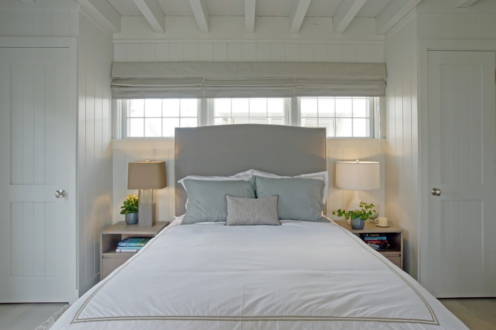 Design ideas for a small beach style guest bedroom in Boston with white walls, light hardwood floors and no fireplace.