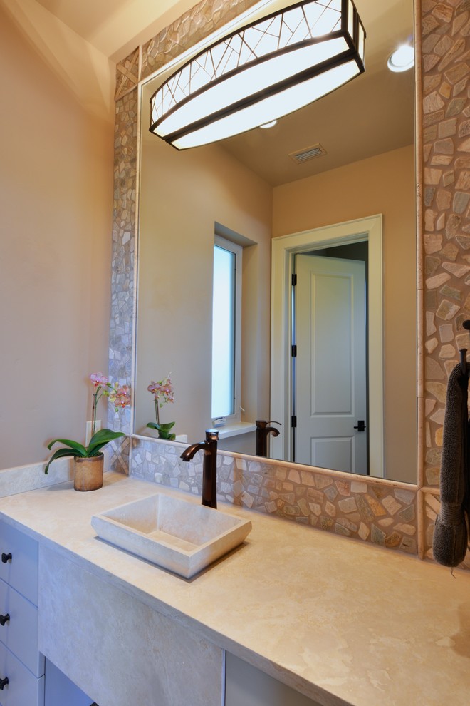 Photo of a mid-sized transitional 3/4 bathroom in Dallas with a vessel sink, flat-panel cabinets, grey cabinets, limestone benchtops, an open shower, a two-piece toilet, beige tile, stone tile, beige walls and travertine floors.