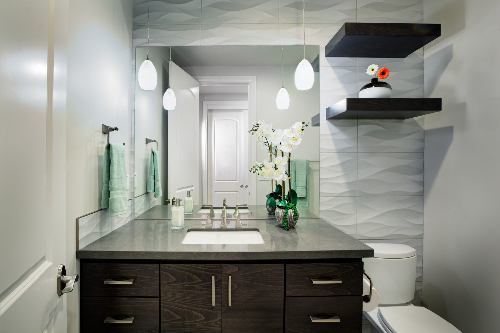 This is an example of a mid-sized transitional bathroom in Sacramento with flat-panel cabinets, brown cabinets, a two-piece toilet, white tile, porcelain tile, grey walls, porcelain floors, an undermount sink, engineered quartz benchtops, grey floor, grey benchtops, a single vanity and a built-in vanity.