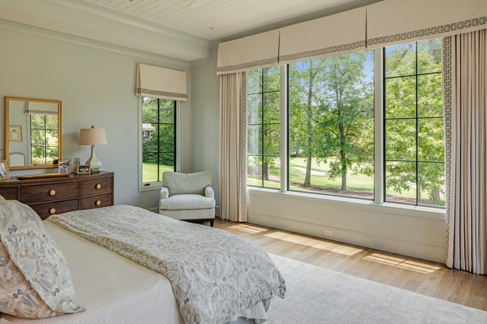 Design ideas for a large transitional master bedroom in Other with blue walls, light hardwood floors and wood.