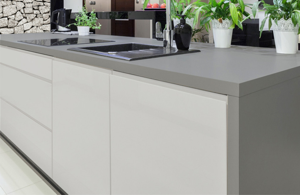 This is an example of a contemporary eat-in kitchen in Other with white cabinets, with island and grey benchtop.