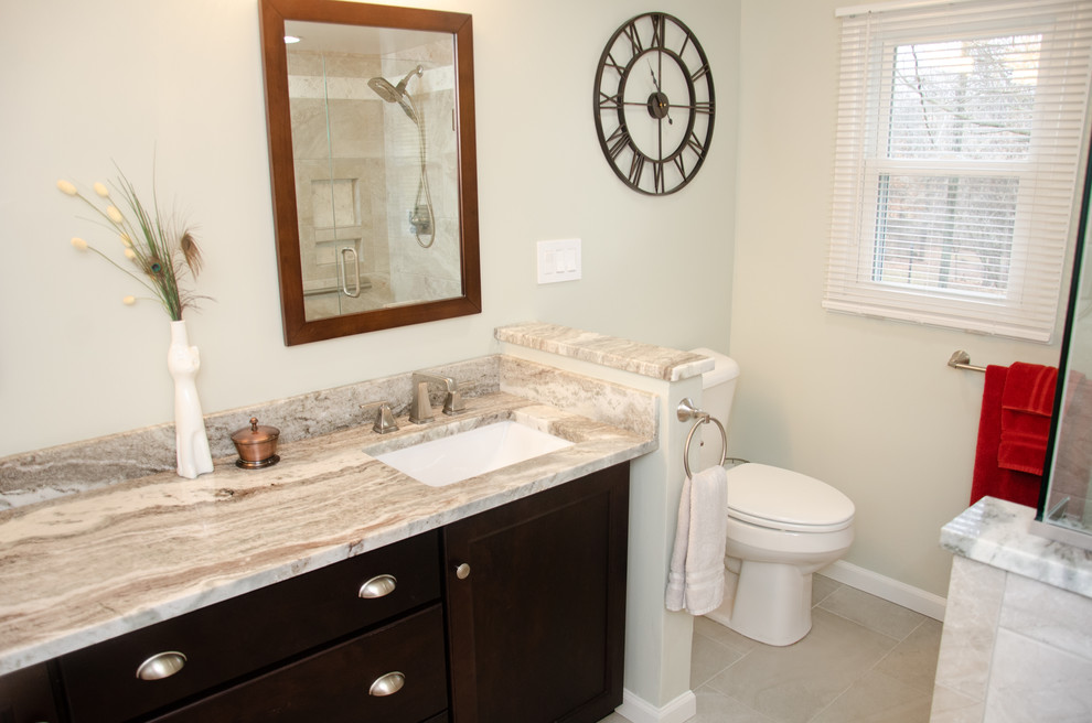 Mid-sized transitional master bathroom in Detroit with recessed-panel cabinets, brown cabinets, an alcove tub, an alcove shower, green walls, porcelain floors, an undermount sink, granite benchtops, grey floor, a hinged shower door and brown benchtops.