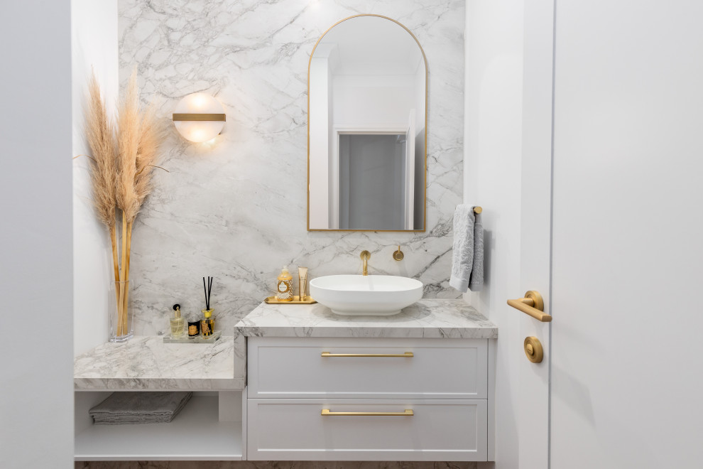 Mid-sized contemporary powder room in Melbourne with shaker cabinets, white cabinets, a one-piece toilet, a vessel sink and a built-in vanity.